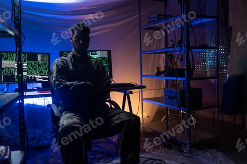 Preview: Anonymous hacker in military unifrorm on dark web, cyberwar concept.