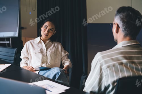 Preview: Pensive Asian female employee with digital tablet cooperate with male colleague
