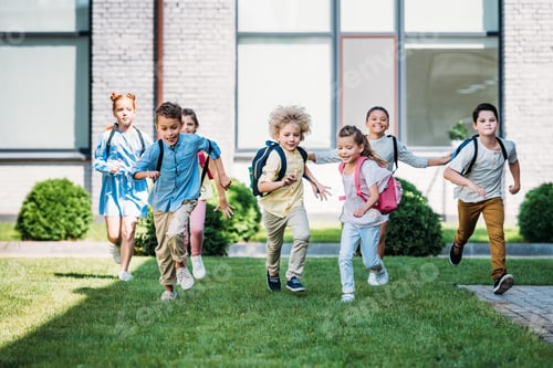 Preview: group of adorable pupils runing by school garden