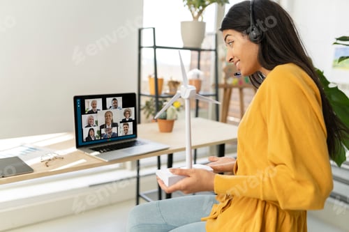 Preview: indian businesswoman wearing headset having virtual team meeting on video conference call