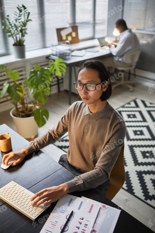 Preview: Young Asian Businessman Working at Desk