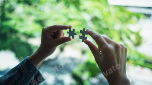 Preview: a woman holding and putting a piece of white jigsaw puzzle together