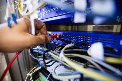 Preview: Close-Up Of Technician Fixing Patch Cable In A Rack Mounted Server