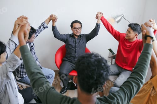 Preview: Young Teacher Celebrate Success With Students While Holding Raised Hands Together