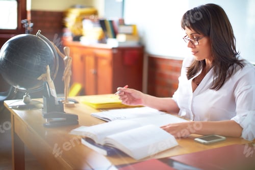 Preview: Teacher writing at desk