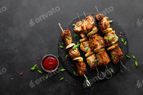 Preview: Grilled meat skewers, shish kebab on black background, top view