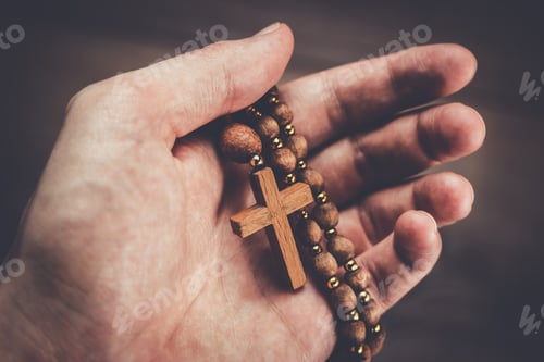 Preview: wooden cross in hand with focus on the cross