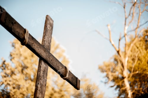 Preview: Low angle shot of a hand made wooden cross with a blurred background