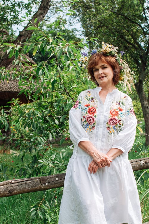 Preview: woman in Ukrainian dress with a wreath of wild flowers on her head