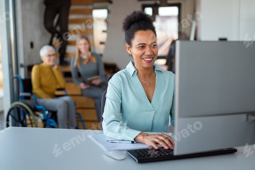 Preview: Business woman working on laptop computer reading financial document report in office