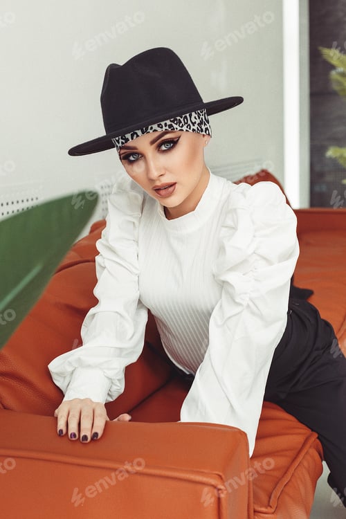 Preview: Stylish Woman Posing in White Top and Hat