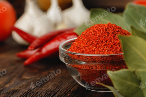 Preview: Red chili spice in glass bowl with herbs on dark table