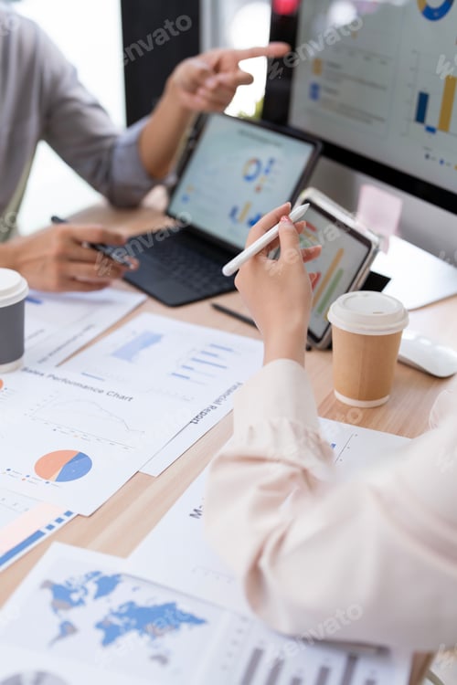 Preview: Professional team analyzing financial data charts and sales reports using a digital tablet