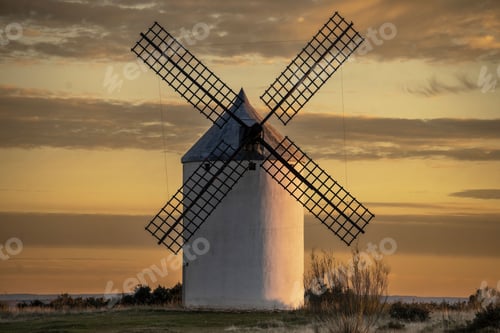 Preview: A picturesque windmill set against a stunning sunset sky in a rural landscape