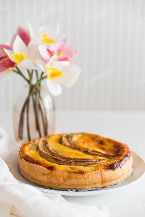 Preview: Banana Tart with Decorative Flowers on White Surface