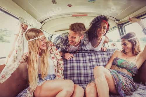 Preview: Happy friends driving a vintage minivan