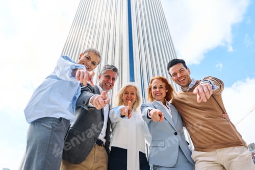 Preview: Group of business people pointing to the camera outdoors