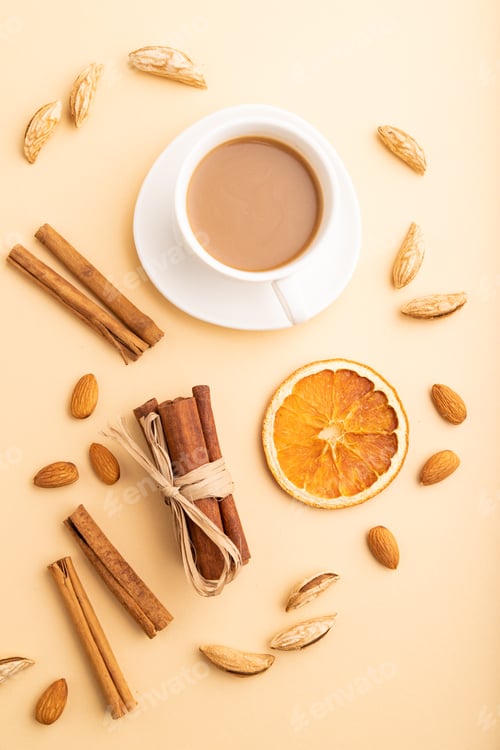Preview: Composition with almonds, cinnamon and cup of coffee on orange pastel background. Blank