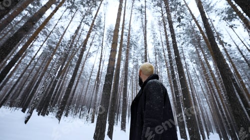 Preview: Caucasian man lost in winter forest. Media. Desperate young hipster man is cold with his red skin