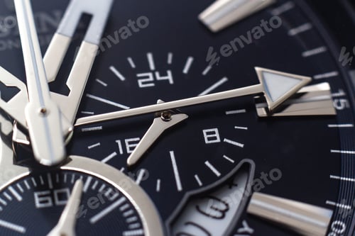 Preview: Closeup shot of the hands, numbers and hour marks of a black watch