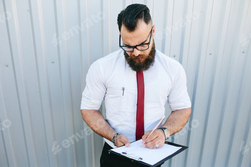 Preview: businessman signs a document