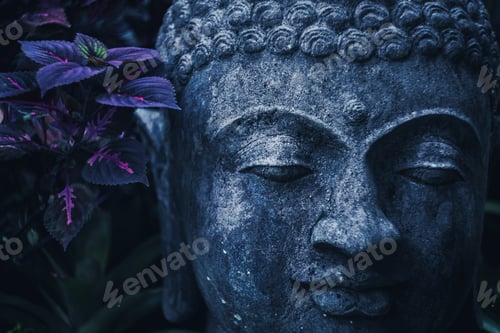 Preview: Stone Buddha face close-up in trend blue color toning. Handmade carved Buddha statue