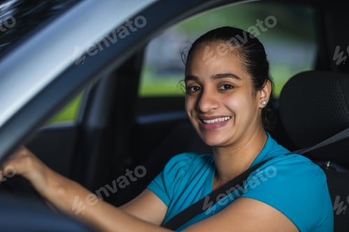 Preview: cheerful latin woman while driving her car