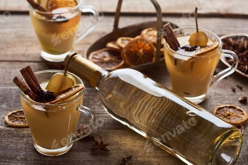 Preview: Seasonal Traditional Pear Mulled Wine With Spices in Glasses Near Bottle of White Wine
