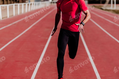 Preview: unrecognizable young athlete man running in the lanes. Daylight. Sports concept