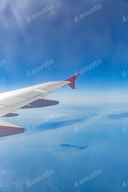 Preview: Aircraft wing on the clouds, flies on the city background
