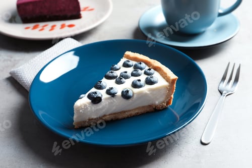 Preview: Plate with piece of tasty blueberry cake on gray table