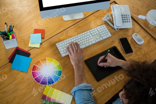 Preview: Graphic designer using graphic tablet and desktop