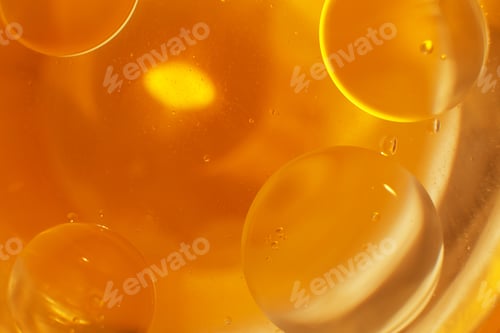 Preview: Gold Oil bubbles close up. circles of orange water macro. abstract shiny yellow background