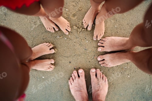Preview: Family enjoying a sunny day at the beach with toes in the sand