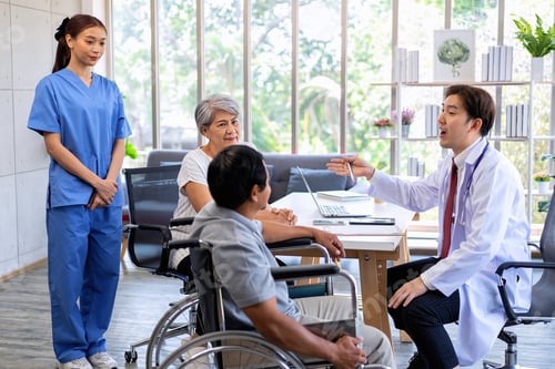 Preview: Senior couple male on wheel chair having consultations with doctor for their sickness at clinic