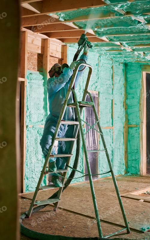 Preview: Worker spraying polyurethane foam for insulating wooden frame house.