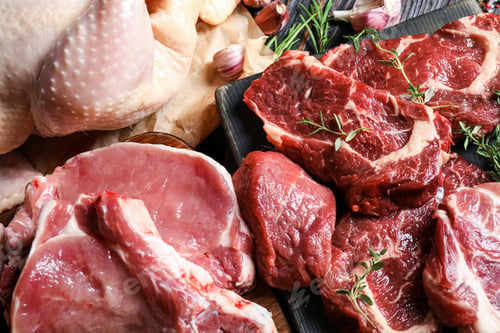 Preview: Closeup view of fresh raw meat and herbs on table
