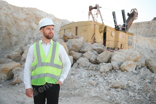 Preview: Extraction of stone. Male worker next to stone quarry. Engineer at construction site