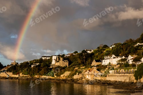 Preview: Cloudy sky with rainbow over Saint Mawes, Cornwall, UK.