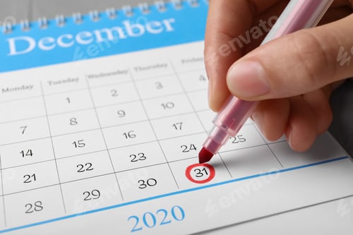 Preview: Woman marking date in calendar, closeup. New Year countdown