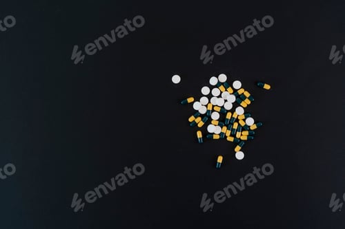 Preview: a small bunch of different medicine pills flat lay on the colorful background, minimalism helthcare