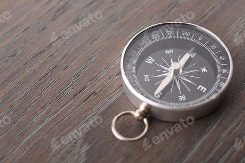 Preview: One compass on wooden table, space for text. Tourist equipment