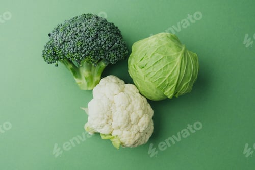 Preview: Healthy fresh broccoli, cabbage and cauliflower on green background