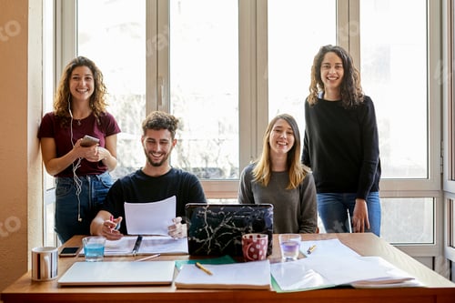 Preview: Portrait of four happy students at desk and at the window