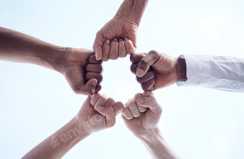 Preview: Cropped shot of a group of unrecognizable businesspeople joining their fists together