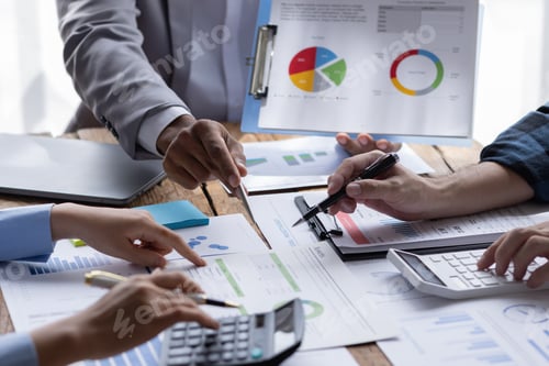 Preview: Group of confident business people point to graphs and charts to analyze market data, balance sheet,