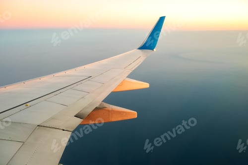 Preview: View from airplane on the aircraft white wing flying over ocean