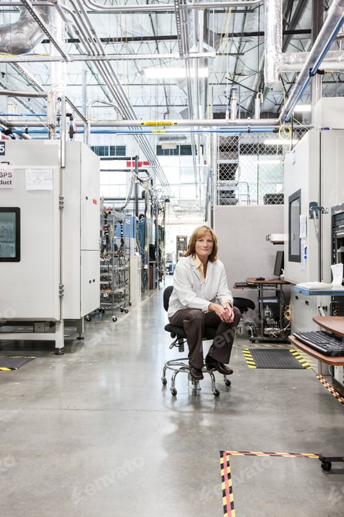 Preview: A portrait of a caucasian female technician in a technical research and development site.