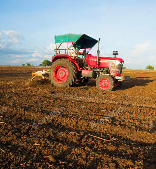 Preview: farmer with tractor preparing land for sowing with cultivator