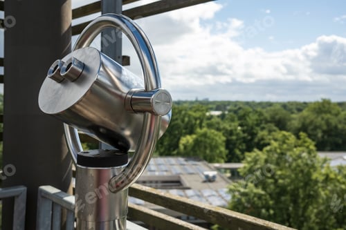 Preview: Tower viewer with city view, rooftops, green trees and blue sky with clouds.